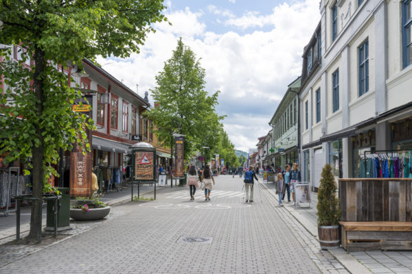 Lillehammer, Norway - June 27, 2016: Tourists enjoying the beautiful weather walking through the streets of Lillehammer.